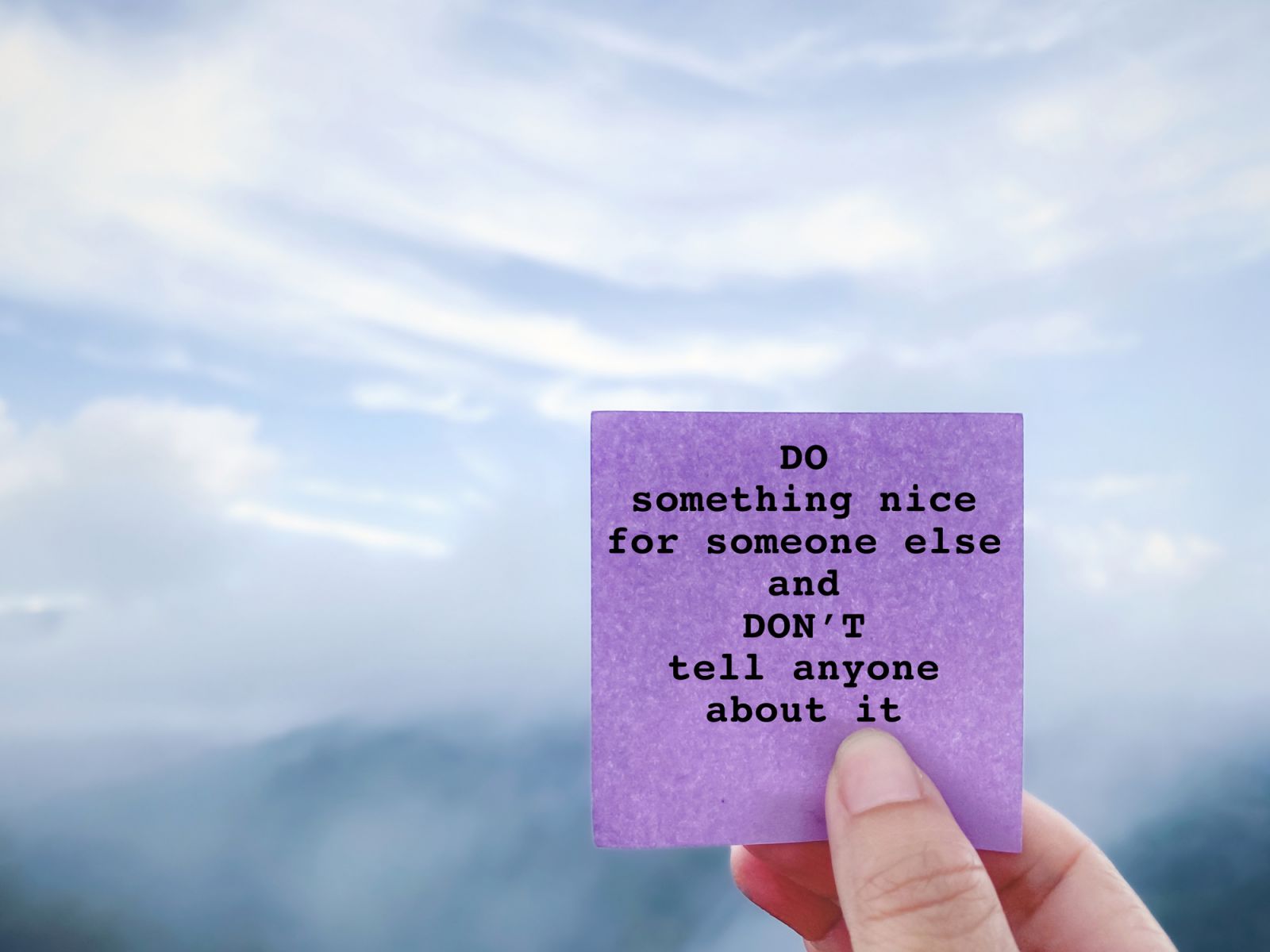 Inspirational Motivational Quote - do something nice for someone else and don't tell anyone about it. With foggy nature background.
