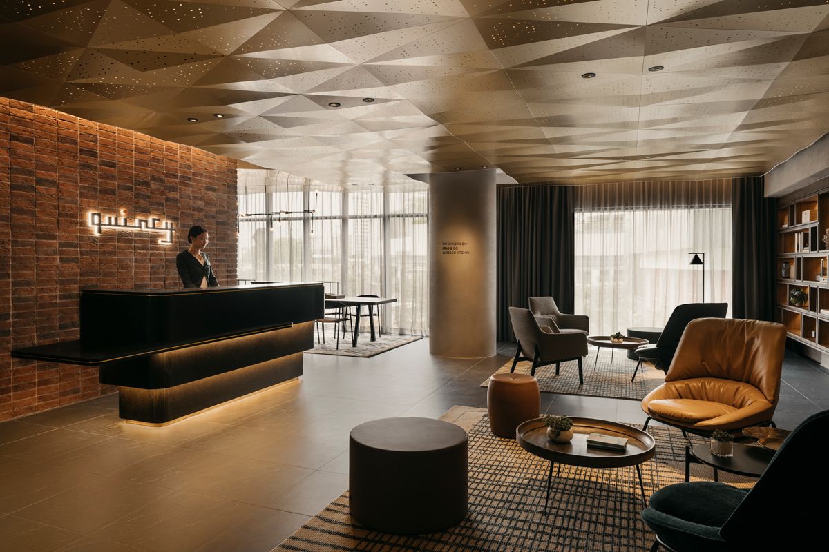 The check-in area is styled as a cosy living room