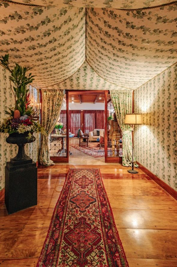 Jaime Ponce de Leon home tour: The entrance of resembling a tent for the feeling of warmth, with the urn as the focal point and faux candle scones
