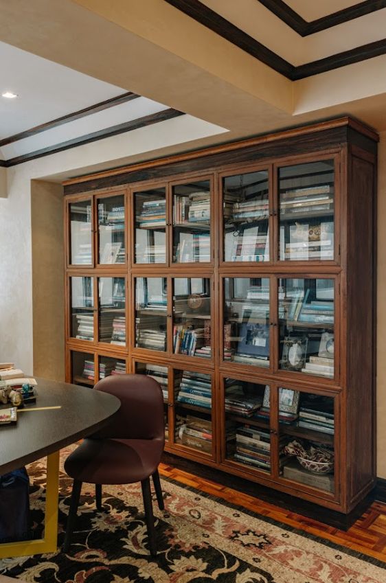 Jaime Ponce de Leon home tour: A 19th century botanica cabinet used as a library for books; Jaime Ponce de Leon poses for a photo; The bamboo hardware for the doors that were custom-made in narra and balayong wood