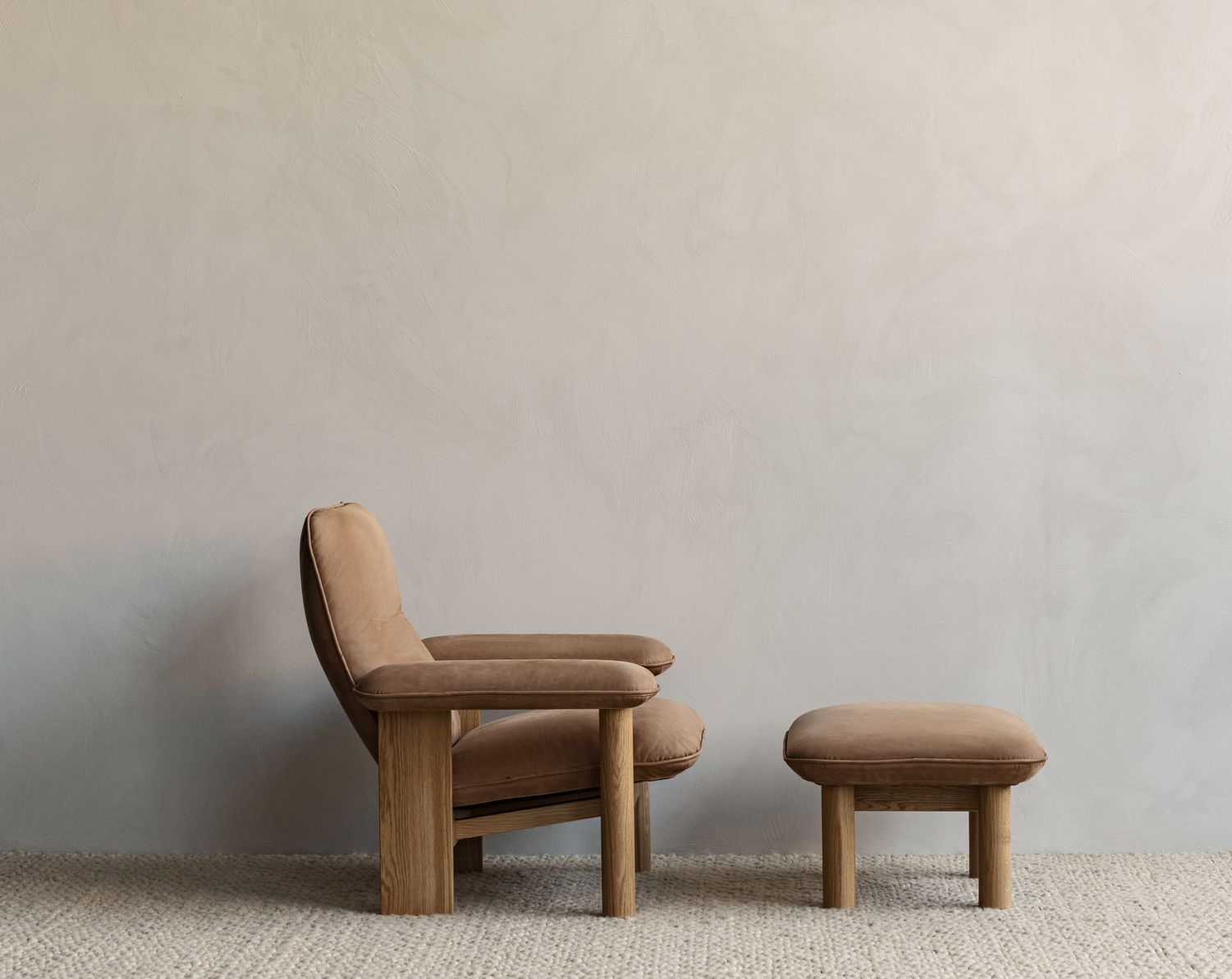 Featuring exaggerated armrests, cylindrical front legs, and a broad wooden back (Photo: Audo)