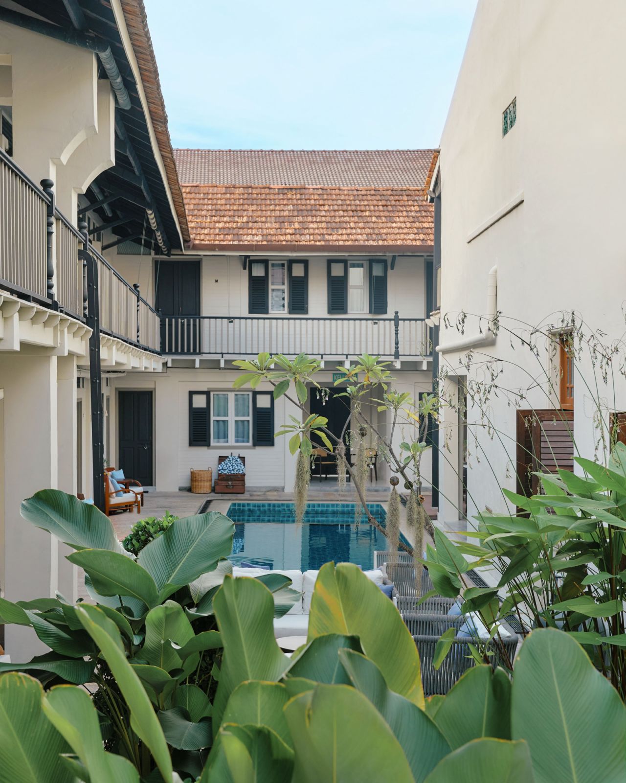 Architectural details of the former mews reveal the building's equestrian heritage, with restored wooden shutters, white corbels, and traditional pitched roofing maintaining its authentic character
