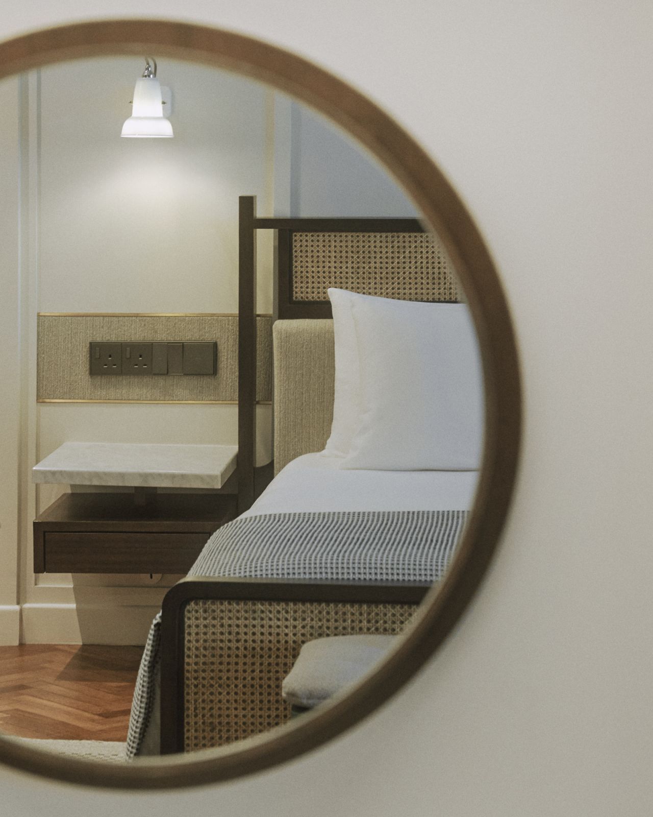 The newly renovated guest rooms at Noordin Mews feature rattan headboards, custom-built furniture, and thoughtfully placed modern amenities, reflecting the hotel's blend of heritage and contemporary comfort.