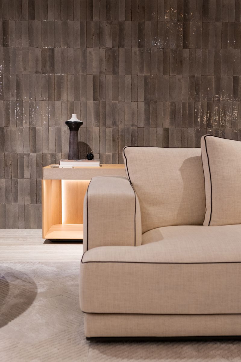 A handsome vignette dressed in glossy subway tiles and Molteni&C furniture