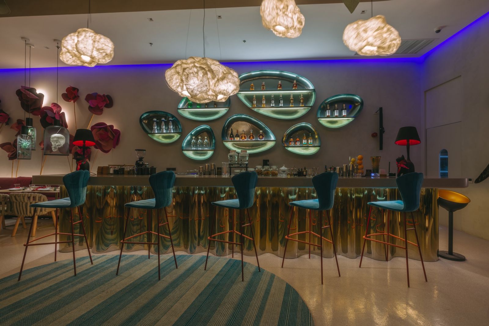 The bar area with seashell chairs beneath the Cloud Hanging Lamps