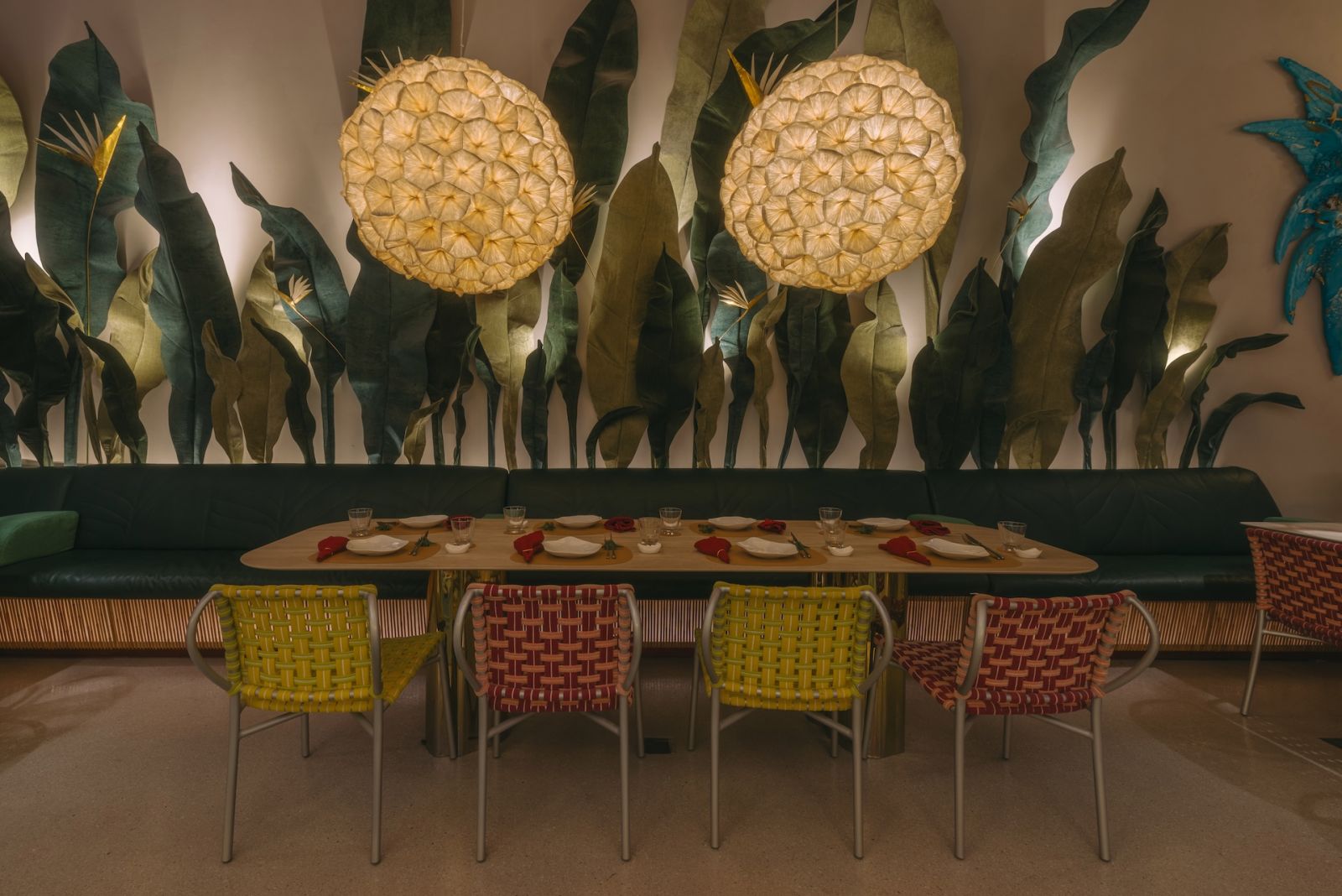 One of the tables in the café, featuring the Poppy Hanging Lamps