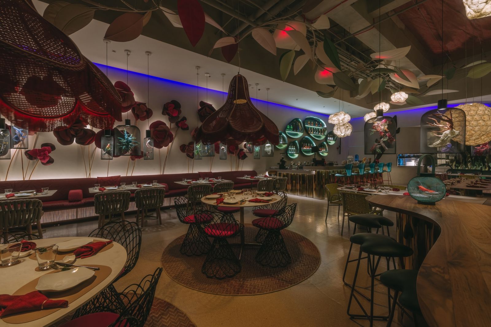 Exploring the otherworldly café with distinctive handcrafted flowers on the wall and over the tables