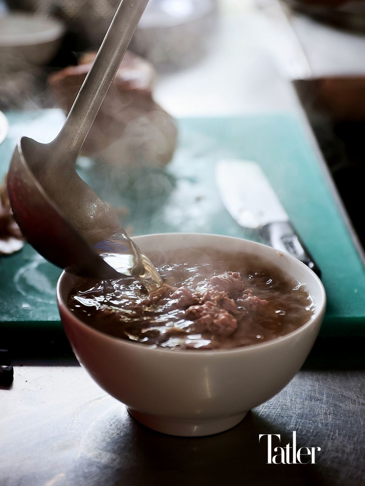 A delicious bowl of pho lies in the broth.