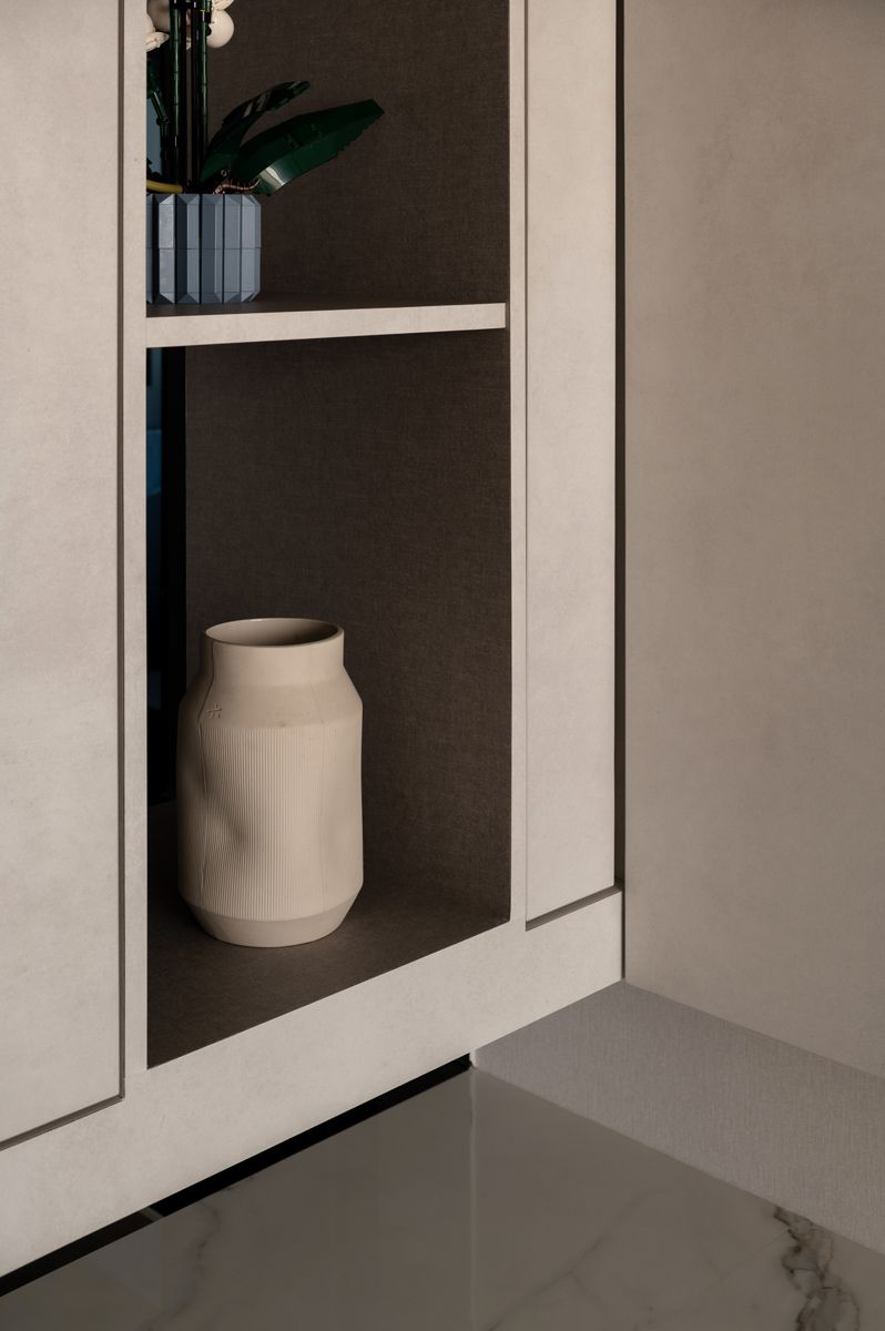 A curated selection of objects on display shelves add personality to the space