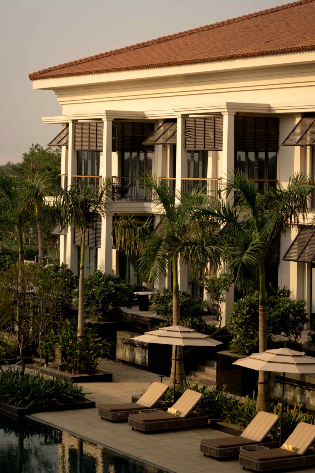 Traditional black Bahama shutters and Juliet balconies punctuate the warm white exterior (Photo: Avesh Gaur)