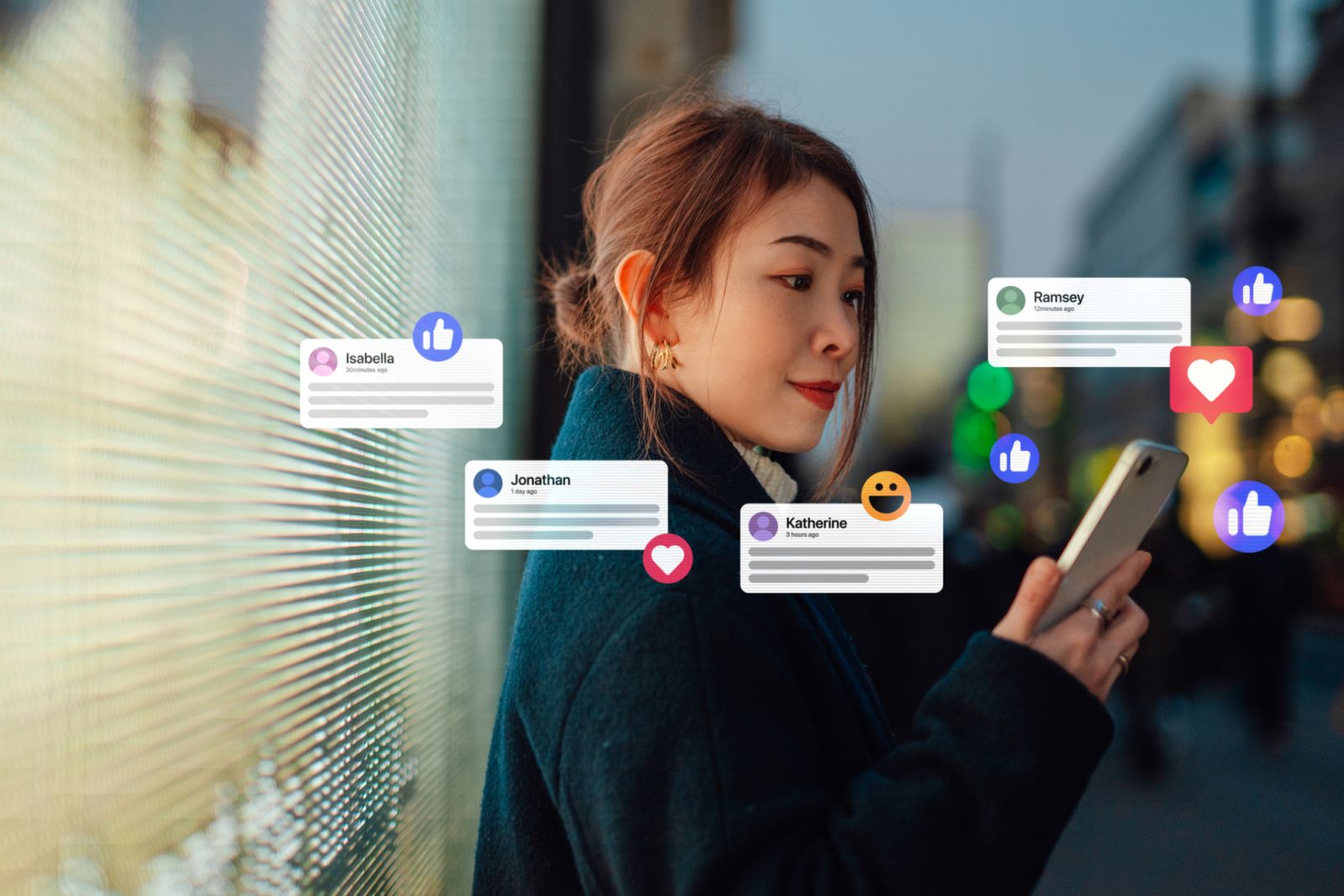 Young woman receiving notifications from social media platform on mobile phone, standing against digital display on the street in the city at night. Futuristic concept. Social media and marketing concept.