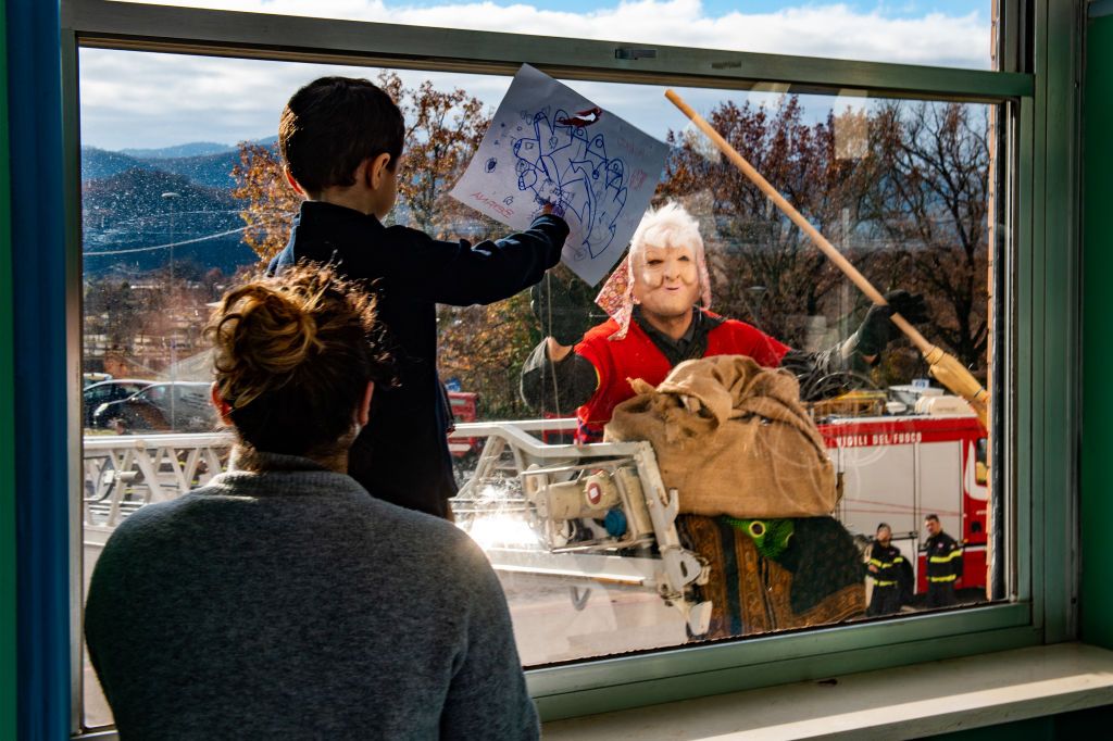 A child waits for the Rieti Fire Brigade's Befana on 6 January 2023 at the San Camillo de Lellis Hospital in Rieti. (Photo by Riccardo Fabi/NurPhoto via Getty Images)