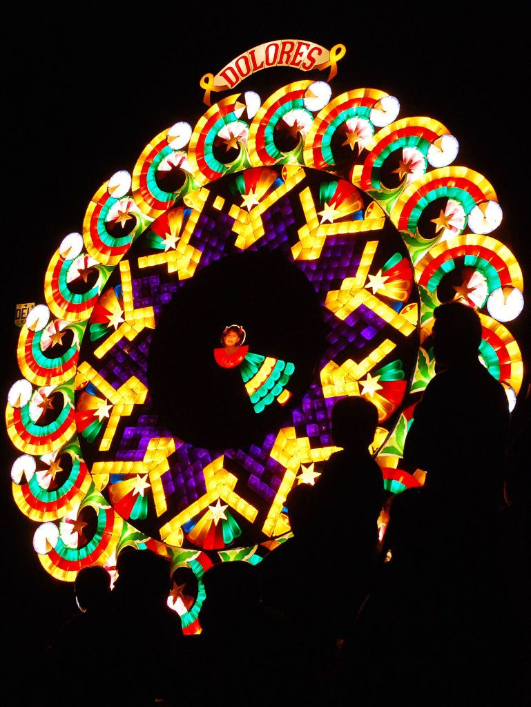 SAN FERNANDO, PHILIPPINES - DECEMBER 18: Spectators watch a light display during the Giant Lantern Festival on December 18, 2010 in San Fernando, Pampanga, Philippines. Giant lanterns averaging 20 feet in height and lit with at least 3,000 light bulbs will compete for the top prize in the competition, which has a tradition dating back to the mid 1920's. Pampanga is known as the Christmas capital of the Philippines and is famous for hosting the Giant Lantern Festival. (Photo by Dondi Tawatao/Getty Images)