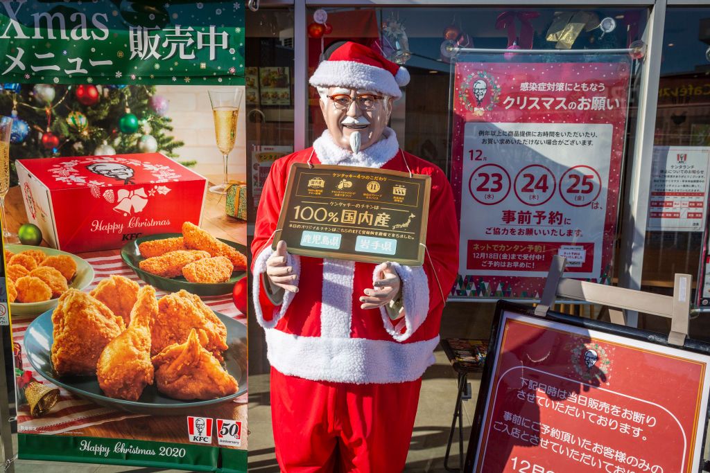 TOKYO, JAPAN - DECEMBER 23: A statue of Colonel Sanders in Santa outfit is pictured on December 23, 2020 in Tokyo, Japan. KFC at Christmas has become something of a tradition in Japan with some attributing its yuletide popularity to a kindergarten delivery being made in a Santa Claus outfit which was such a success it was requested by a number of other schools and subsequently gave the company the idea of associating its product to Christmas. The chain launched its first Christmas campaign in December 1974,