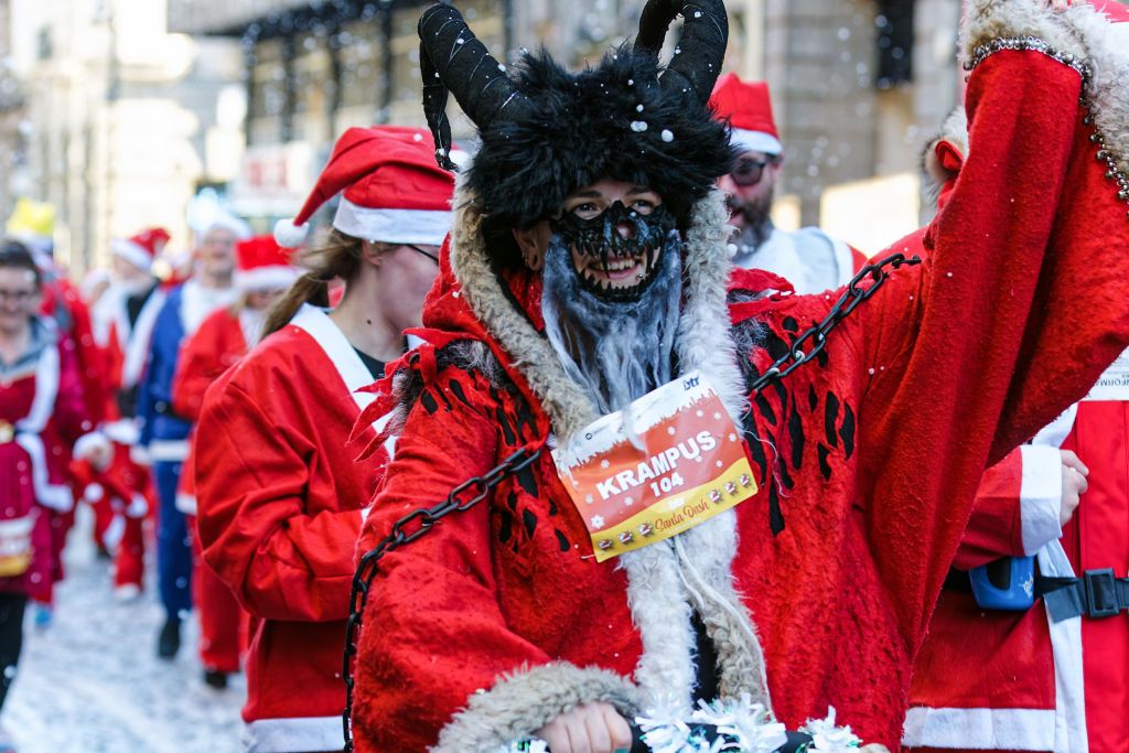 LIVERPOOL, UNITED KINGDOM - 2024/12/01: The Krampus takes part during the Liverpool Santa Dash. Participants donned in red (and blue) Santa suits race along a 5k route around Liverpool city centre in support of Claire House Children's Hospice. 8,500 people took part in the 20th Annual Liverpool Santa Dash. (Photo by Andy Von Pip/SOPA Images/LightRocket via Getty Images)