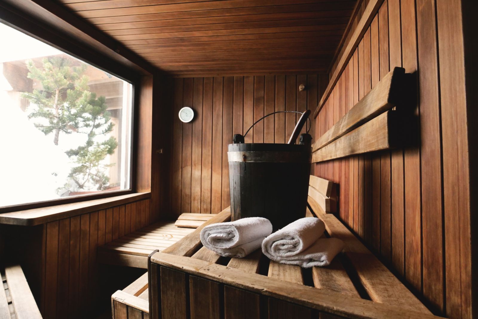 Location of a mountain wood sauna with a large window in which to relax. Concept of: interior design, relaxation, sauna, spa