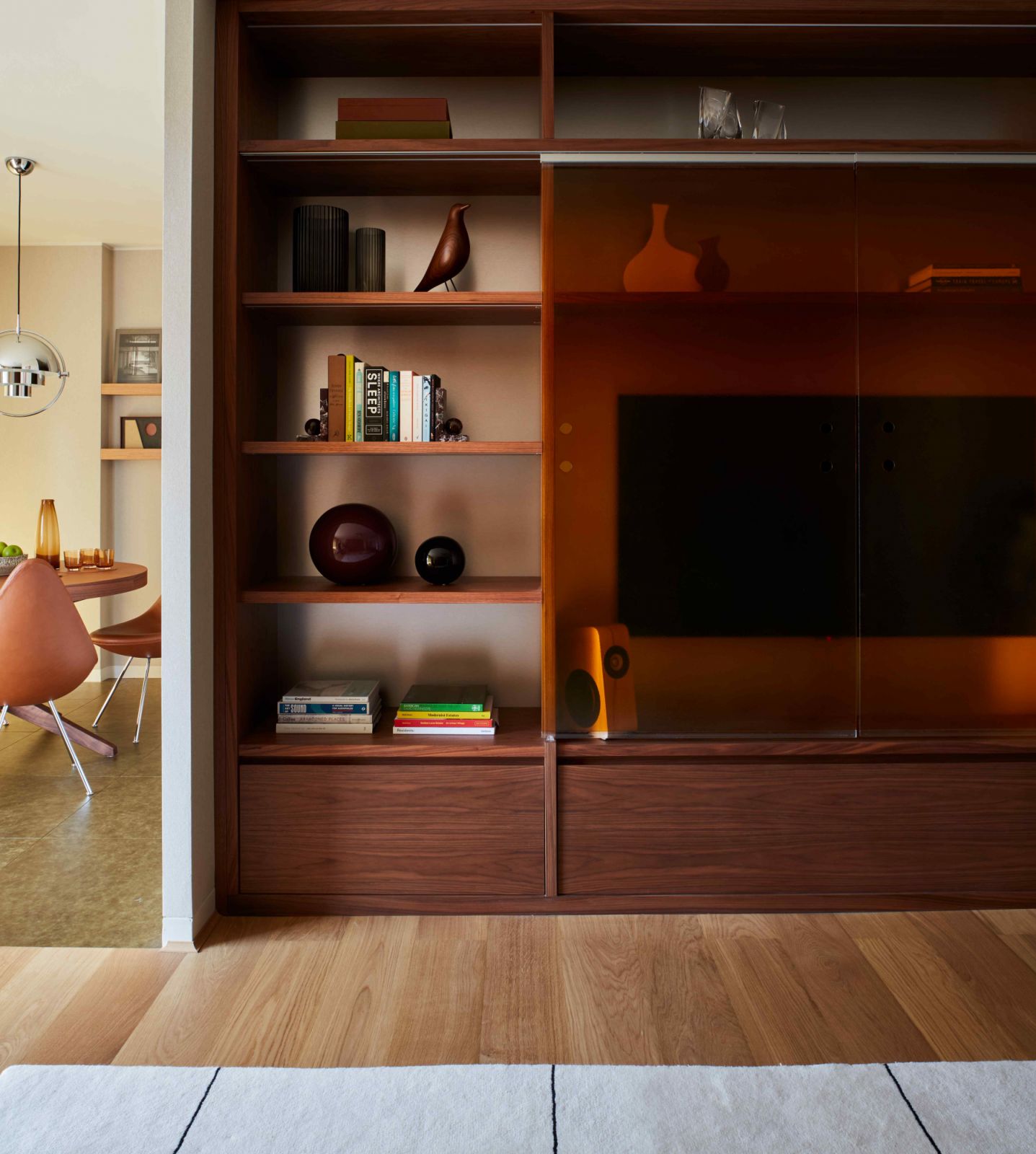 Coloured glass sliding doors to conceal the TV while also showcase display items