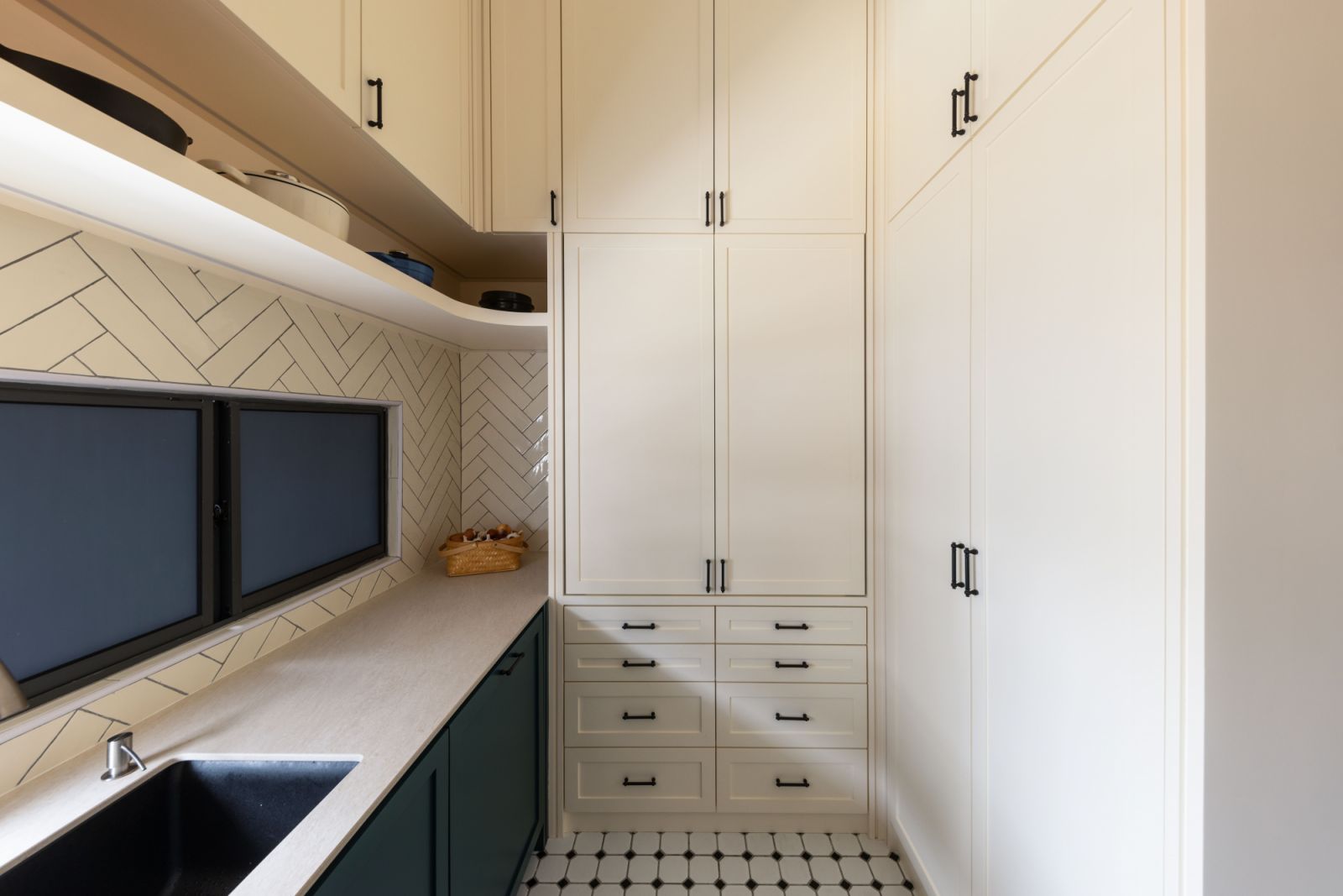 Herringbone tiles and White shaker-style cabinets