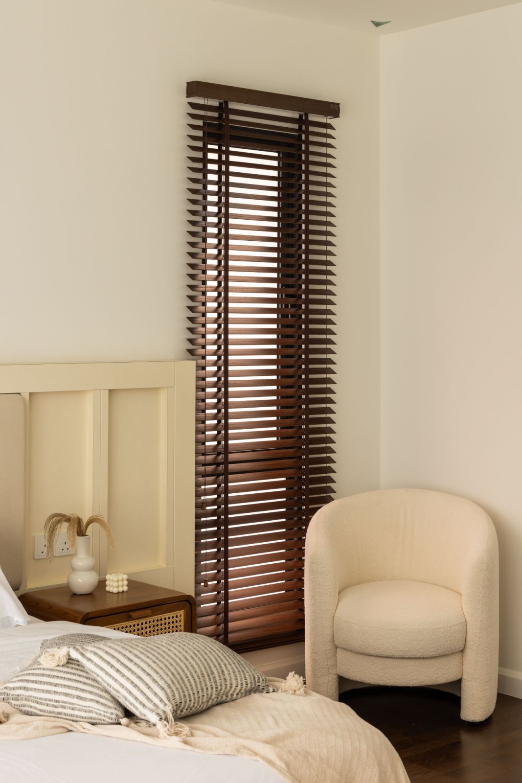 Soft neutrals and plush fabrics create a serene sanctuary in the master bedroom