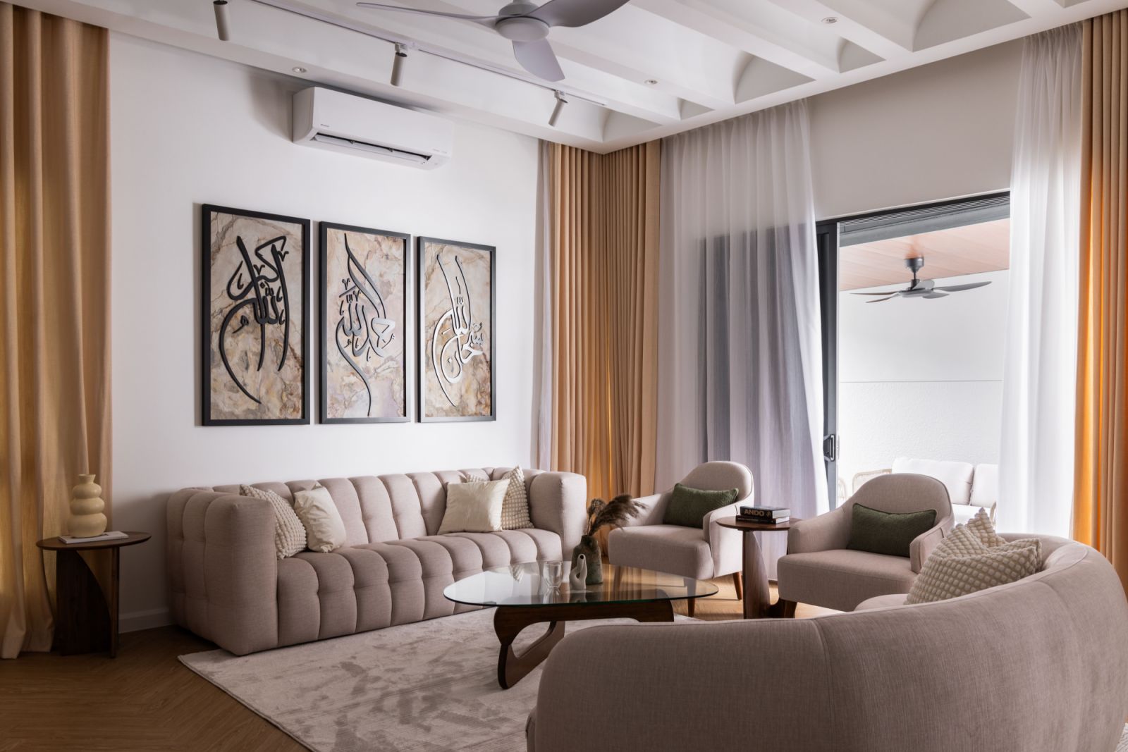 The living room's custom curved ceiling design creates a dramatic interplay of light and shadow