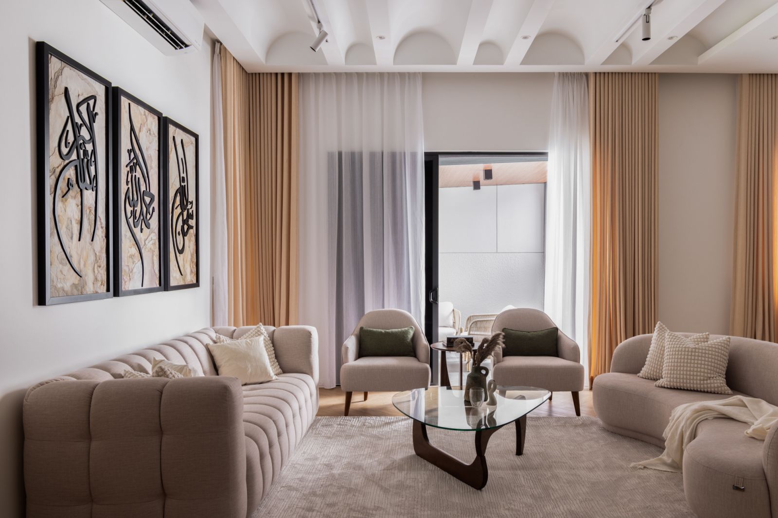 The living room's custom curved ceiling design creates a dramatic interplay of light and shadow