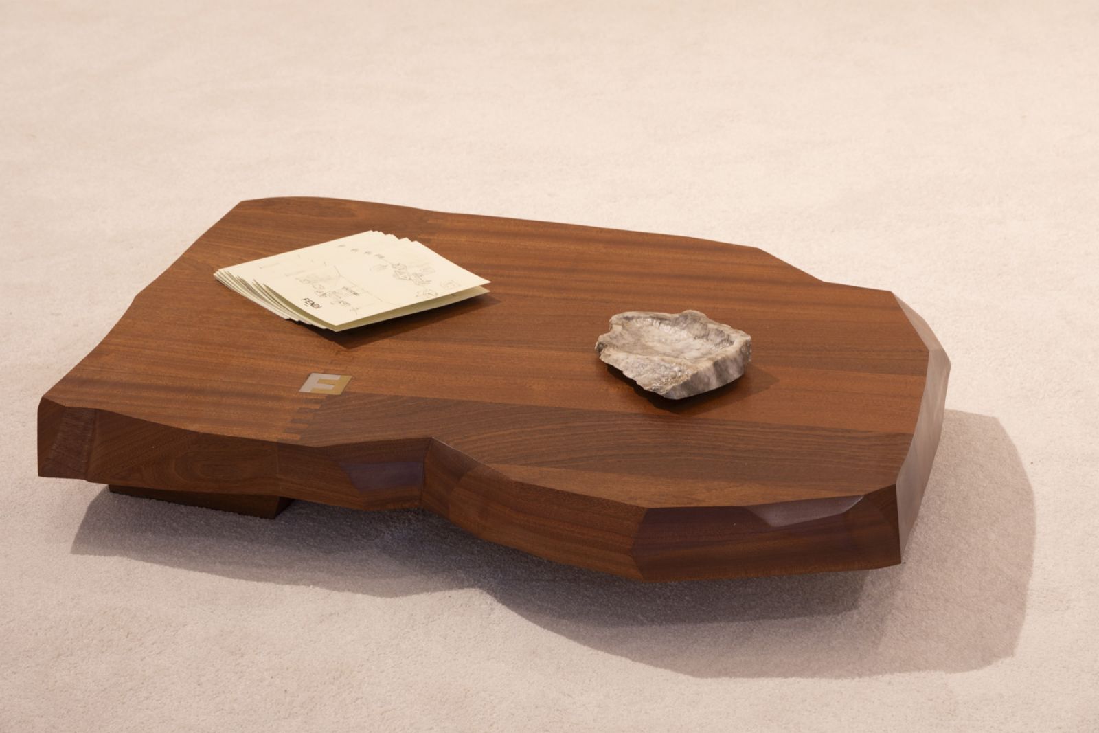 The box joint coffee table made of a Sapele timber slab with hand sliced edges