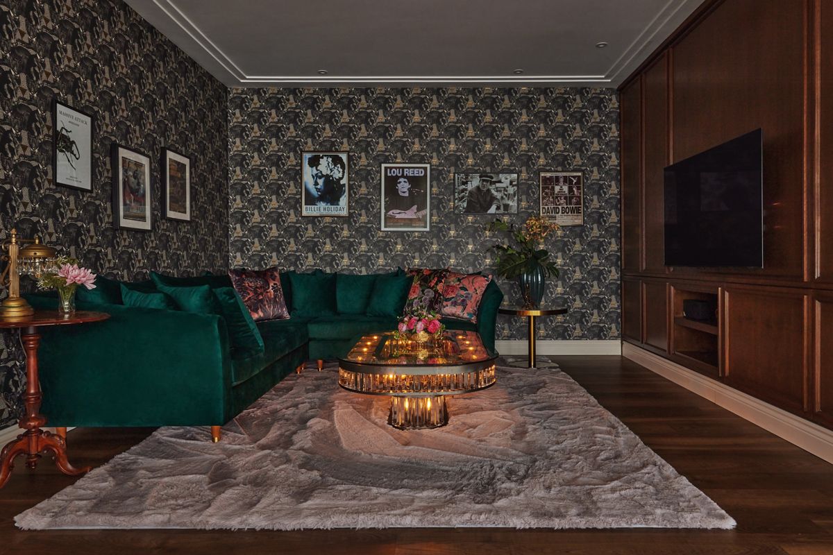 An emerald green sofa stands out in the family room