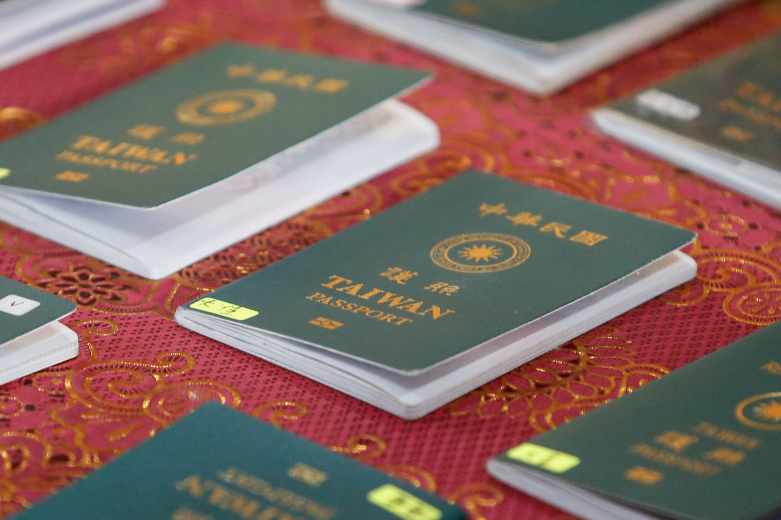 BALI, INDONESIA - 28 JUNE: Passports from detained Taiwaneses are being shown by Indonesian immigration authority during a press conference at the Immigration Detention House in Jimbaran, Bali, Indonesia on 28 June 2024. 103 Taiwanese nationals are being arrested and will be deported later over allegedly committing cybercrime by Indonesian immigration officers and police at a villa in Tabanan, Bali on 26 June 2024. The group are violating the visa permit and allegedly doing online scamming to overseas victi