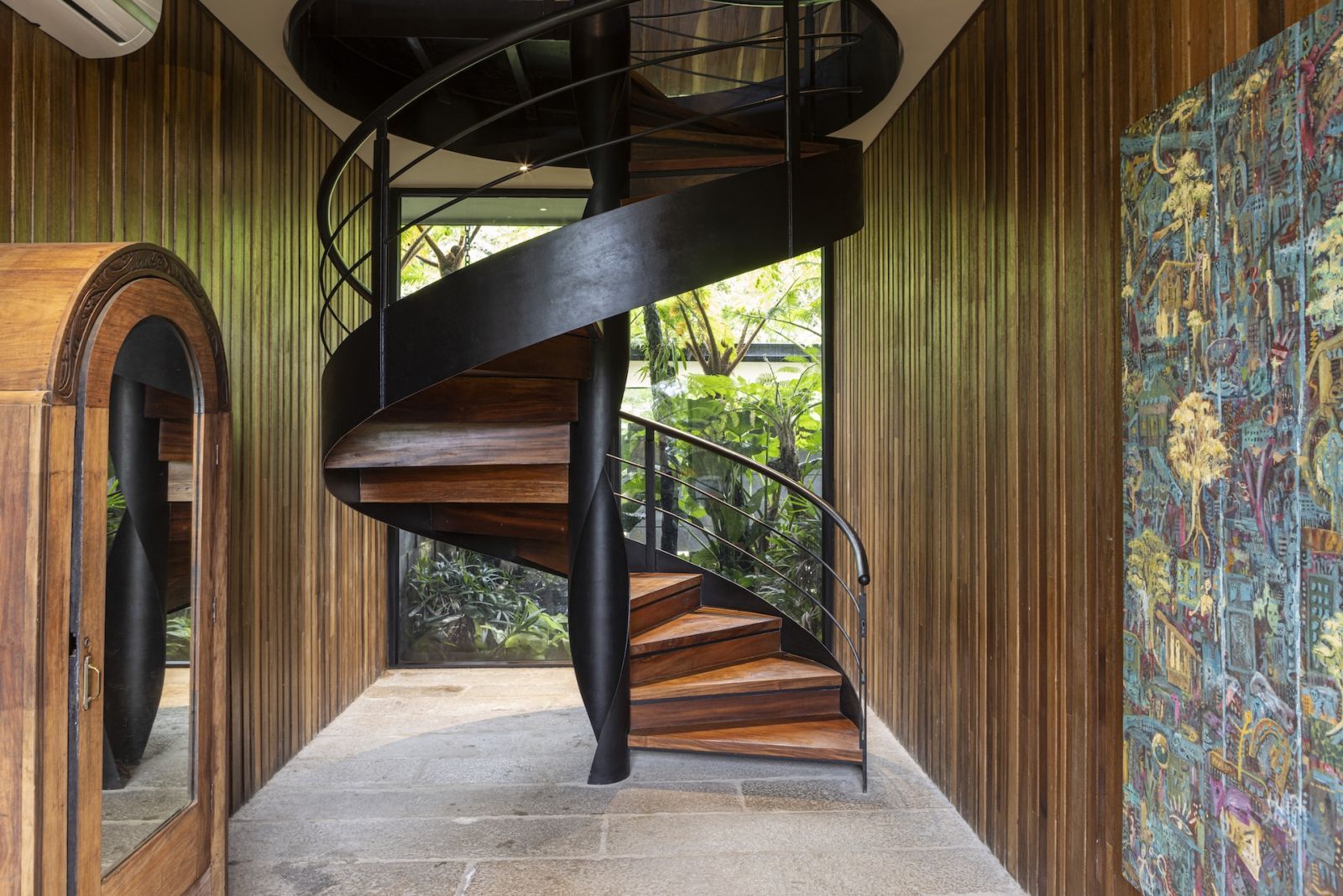 The indoor spiral staircase behind the kitchen, leading up to the hobby lobby in a Quezon home