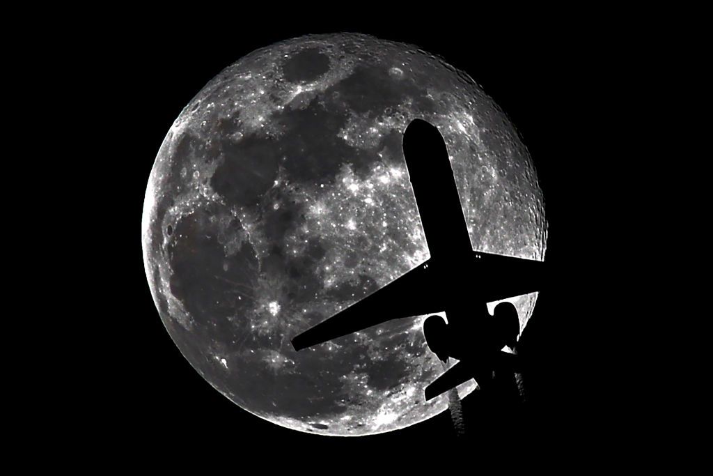 WHITTIER, CALIFORNIA - December 15: An airplane passes in front of a full moon while on approach to Los Angeles International Airport on December 15, 2024 in WHITTIER, CALIFORNIA. (Photo by Nick Ut/Getty Images)