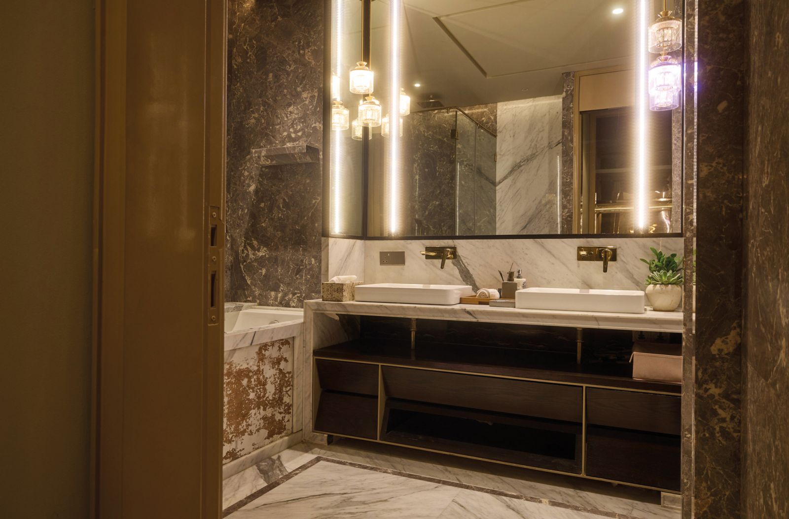 Unica X power sockets seamlessly integrate with this luxurious bathroom’s fittings, adding a touch of elegance to functionality