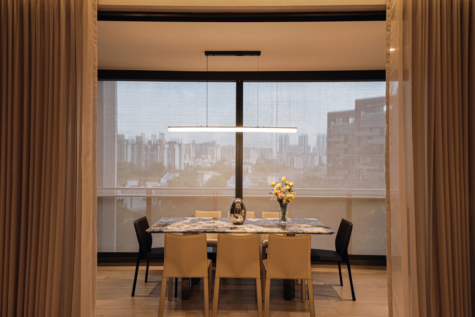 The sizeable balcony is utilised as a dining area to expand the dimensions of the internal living space