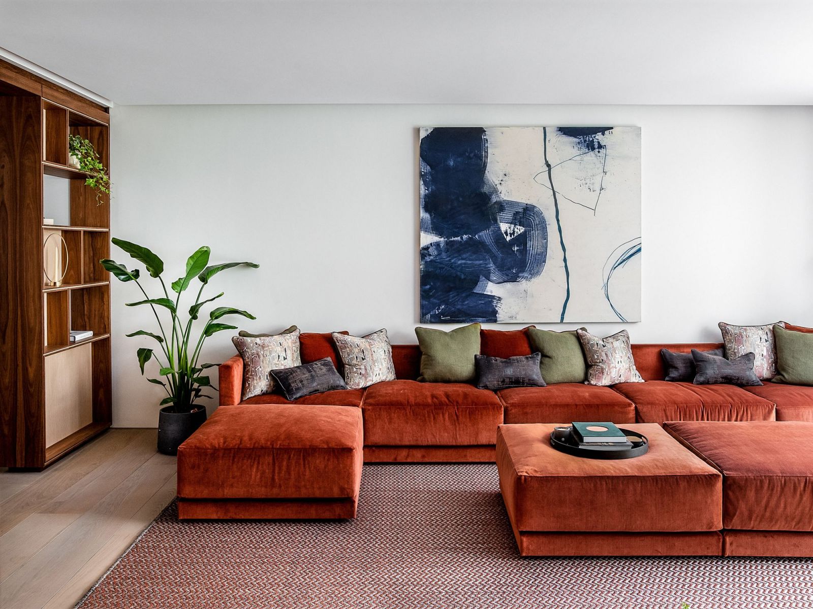 The main living room features a striking five-metre rust orange modular sofa (Photo: Taran Wilkhu)