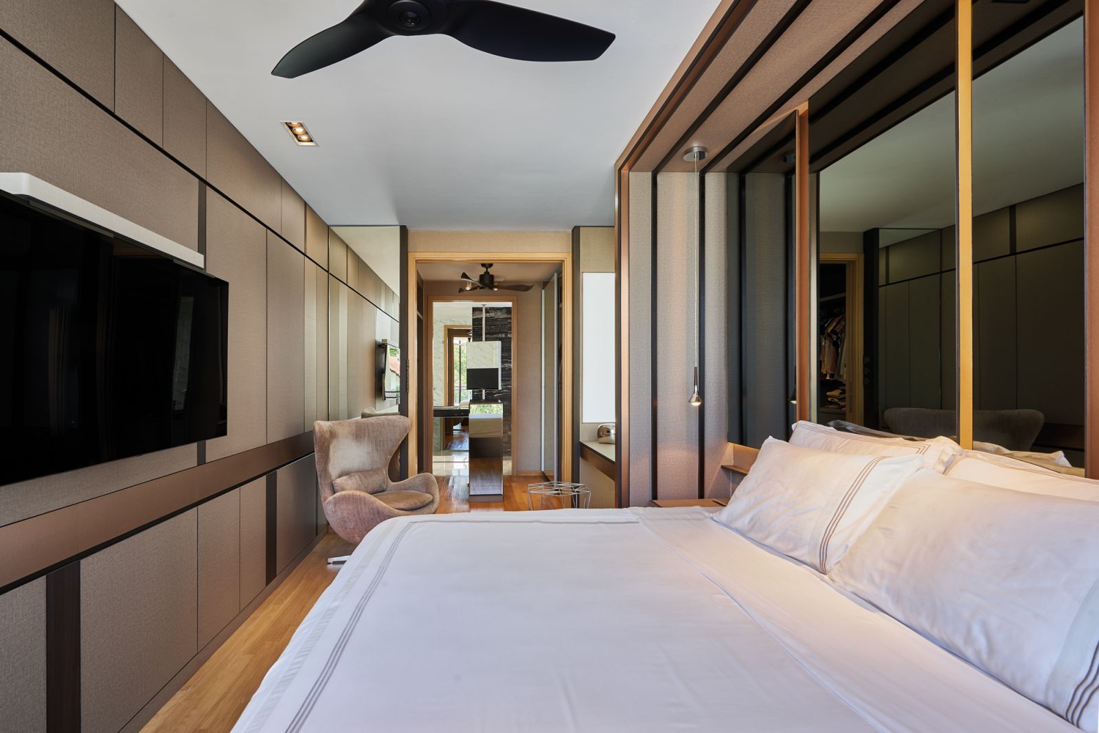 Tinted mirrors are employed to ensure privacy and add a touch of style to this home’s bedroom