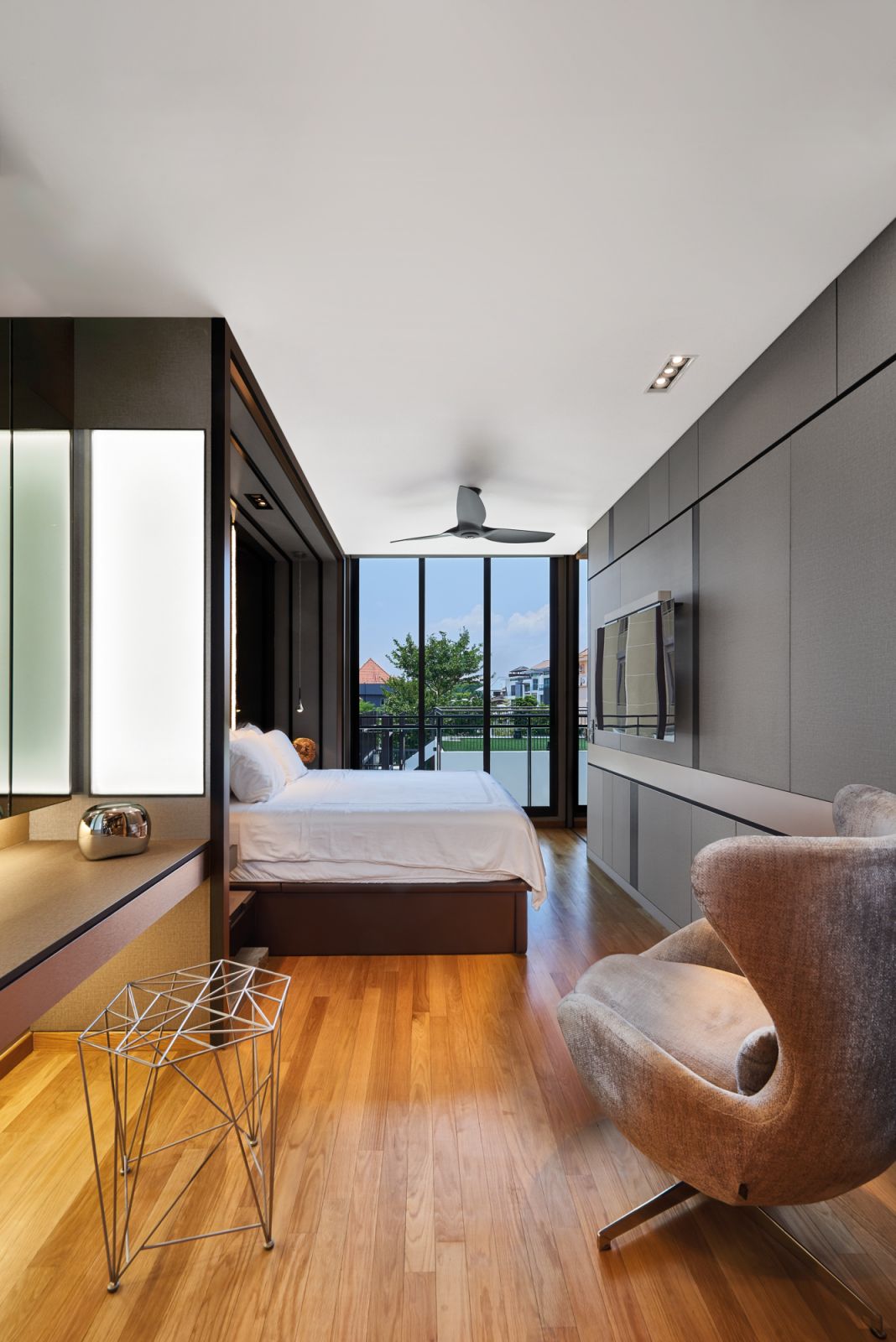 The bedroom includes a stylish vanity furnished with an iconic Fritz Hansen Egg lounge chair