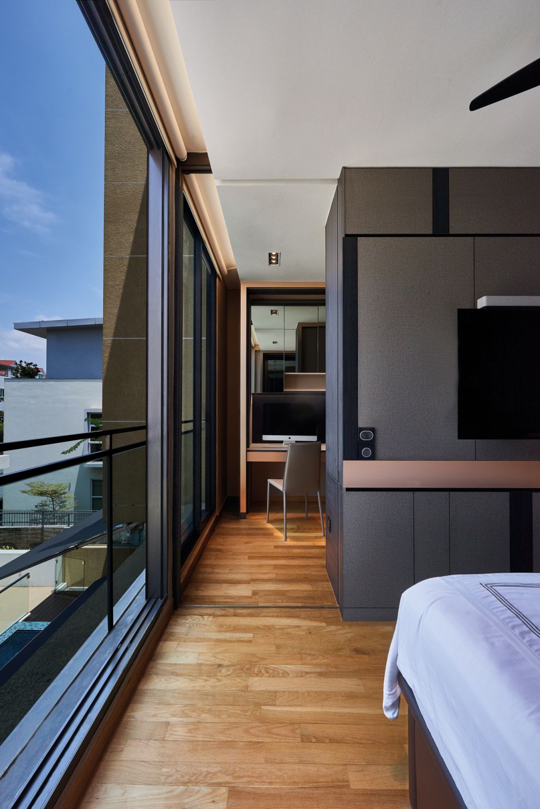 Expansive glazing helps to visually enlarge this compact bedroom