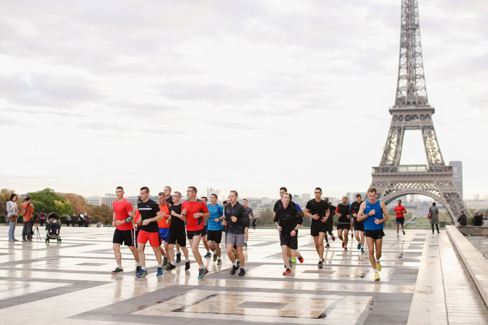 European team of runners running in Eiffel Tower background on Trocadero square, Paris. Concept of sport competition in Europe and France.
