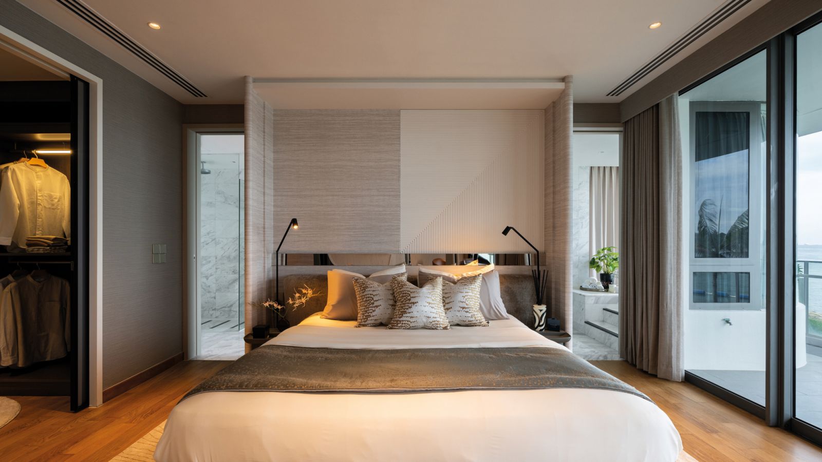 A textural headboard lends a cosy, cocooning effect to the master bedroom