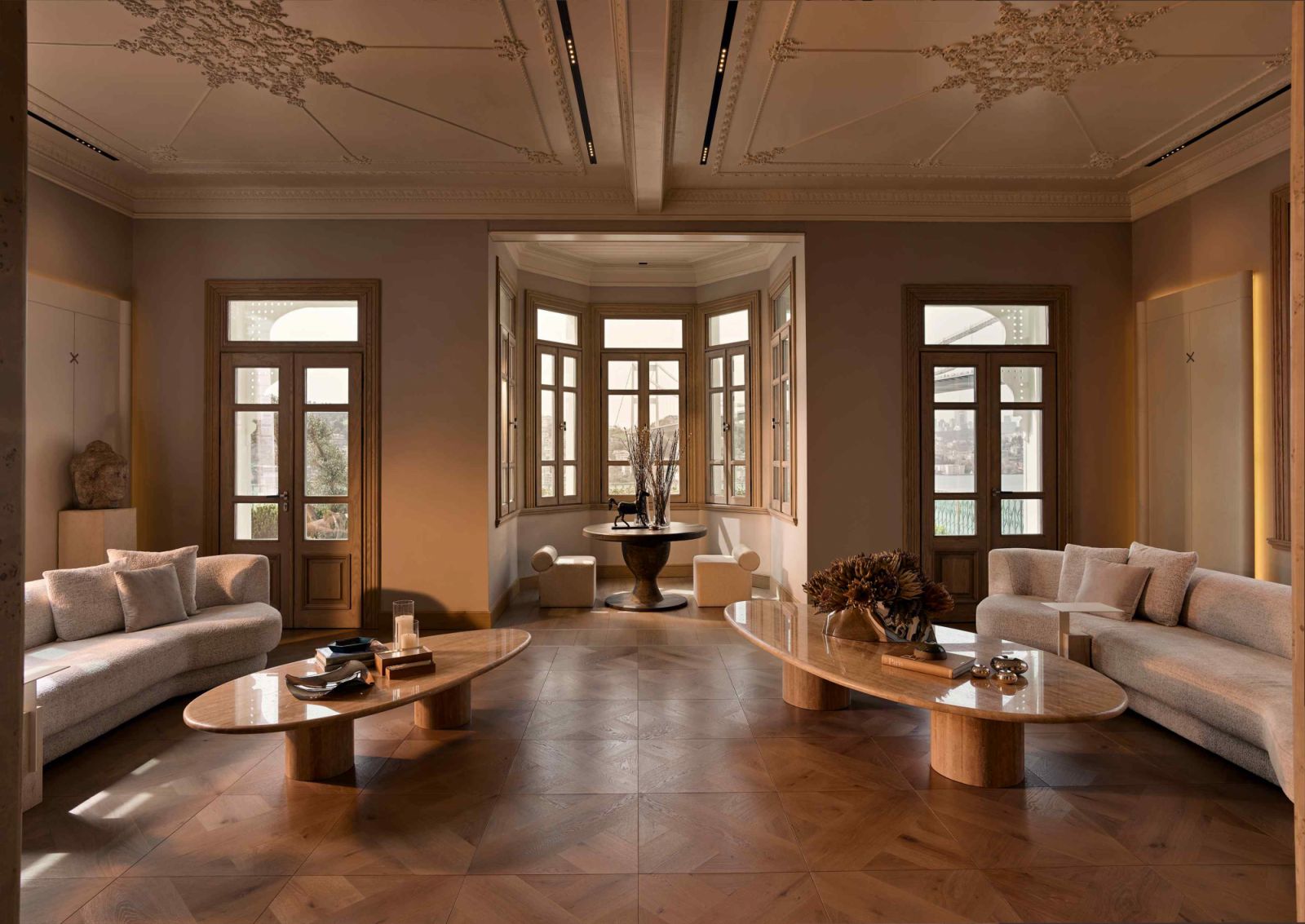 Ornamental handcrafted ceiling mouldings accentuate the grandeur of the living room