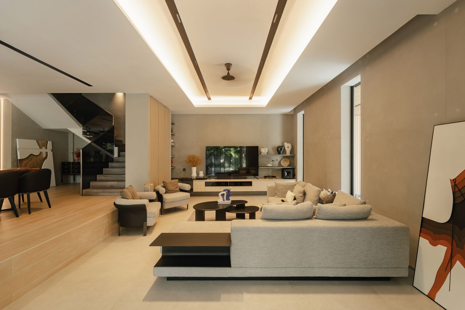 The cosy living room is demarcated from the dining area by elevation
