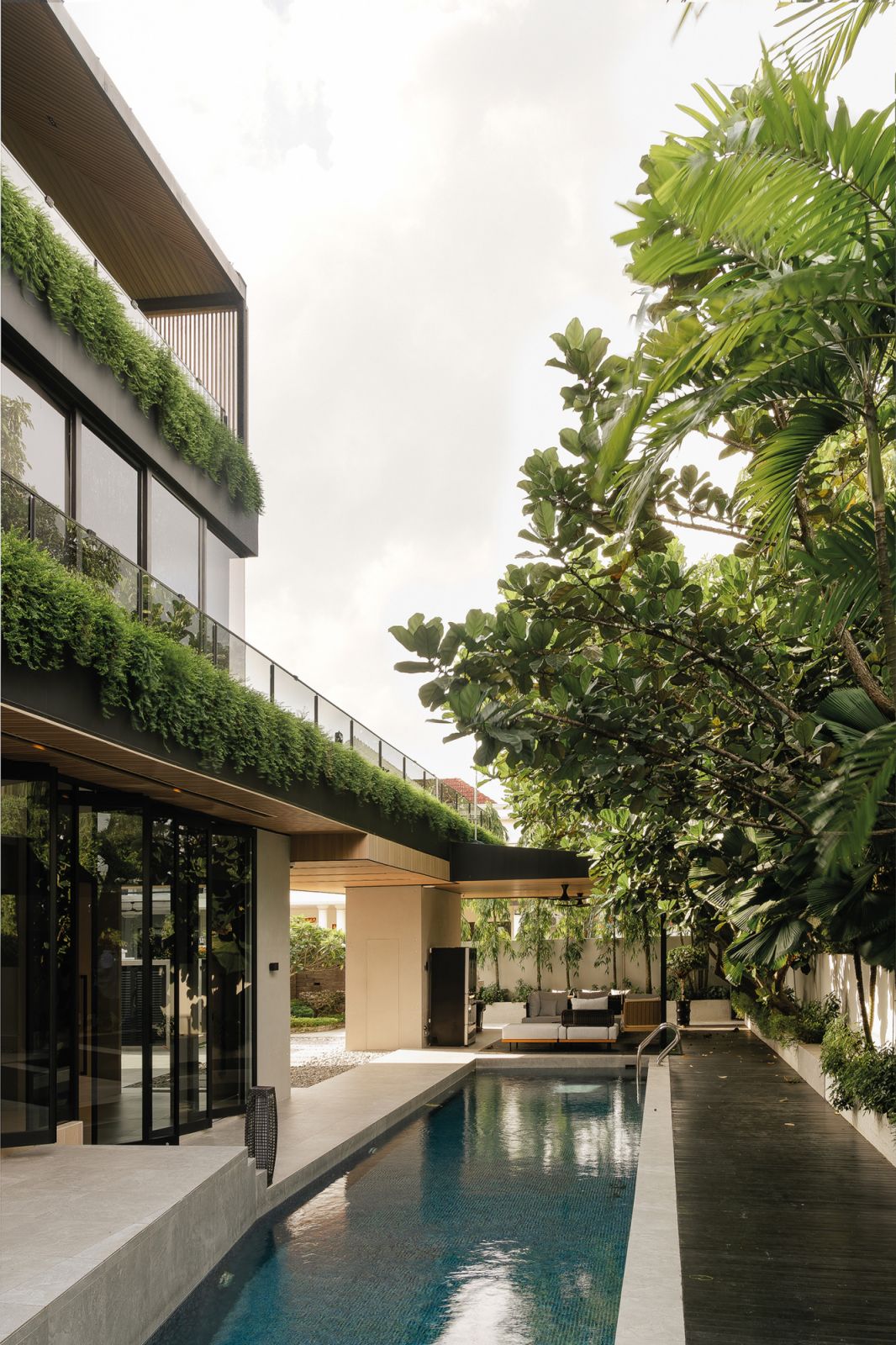 The pool area is surrounded by greenery