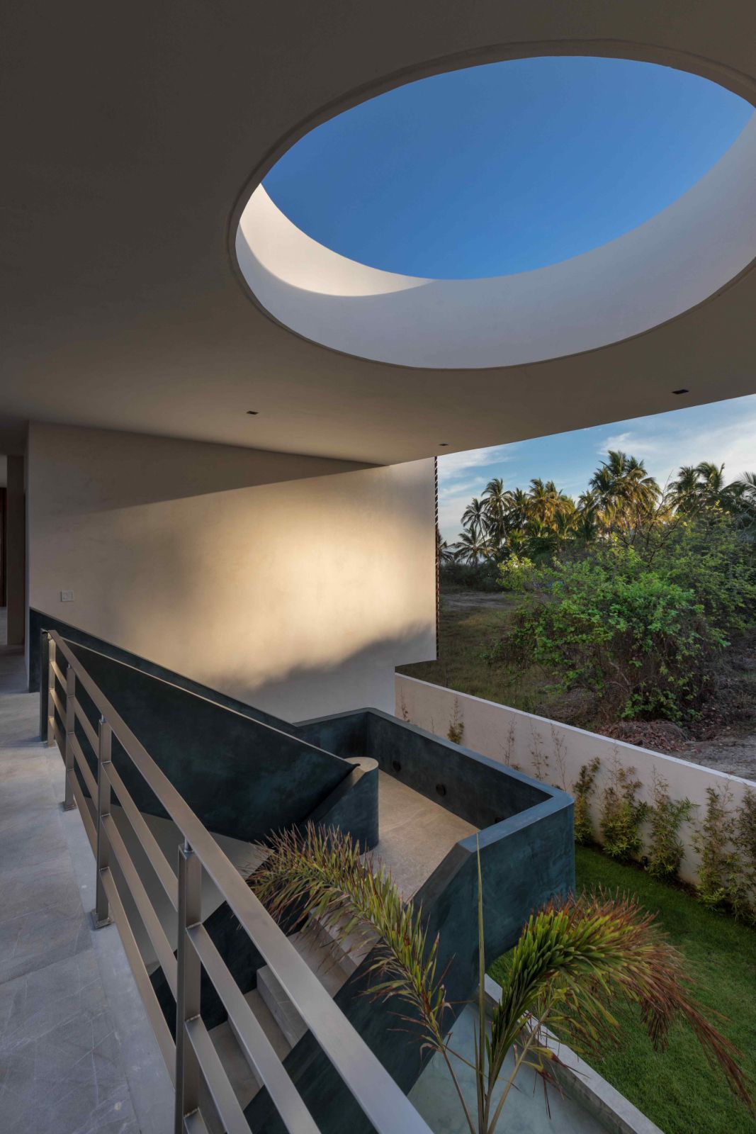 A view of the blue sky through the skylight correlates with the staircase