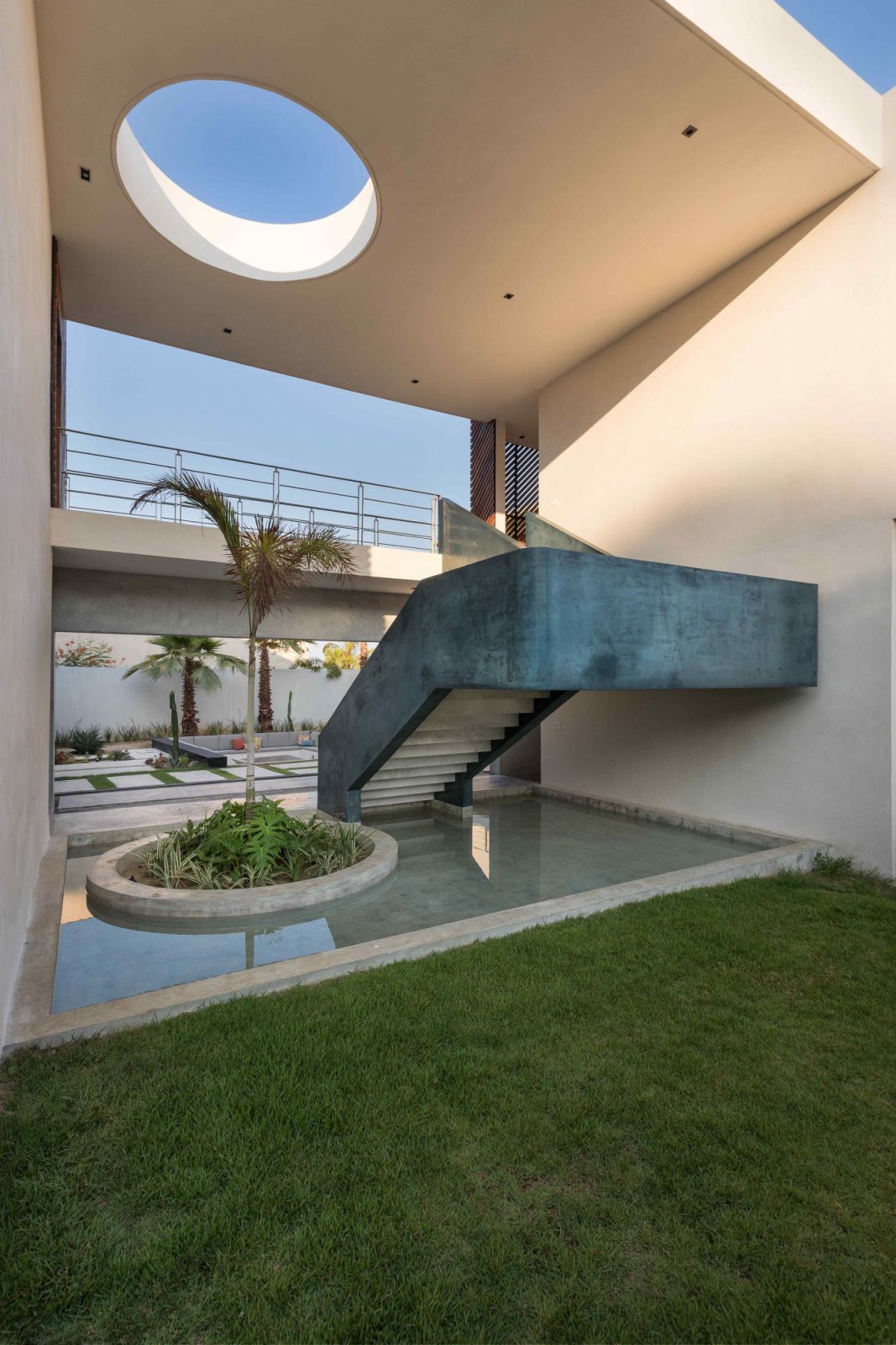 The blue-toned staircase provides a colourful contrast to the neutral hues
