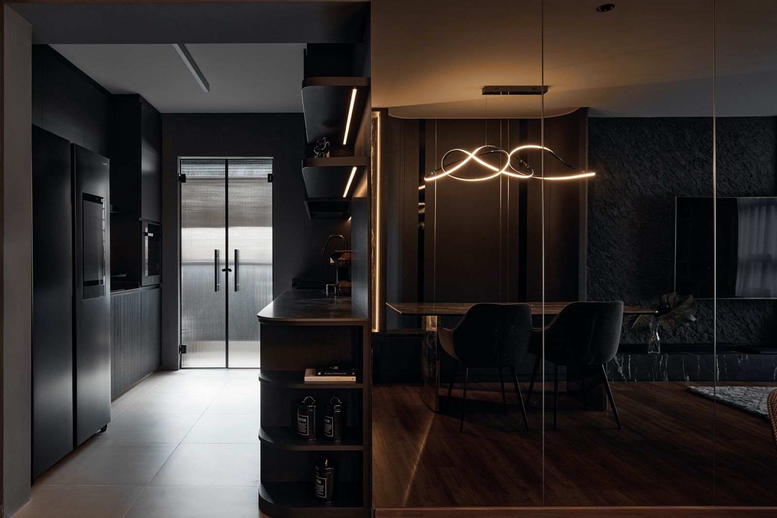 The dining area was slotted into a recessed nook adjacent to the living room, characterised by  a curved wall that hugs the custom settee
