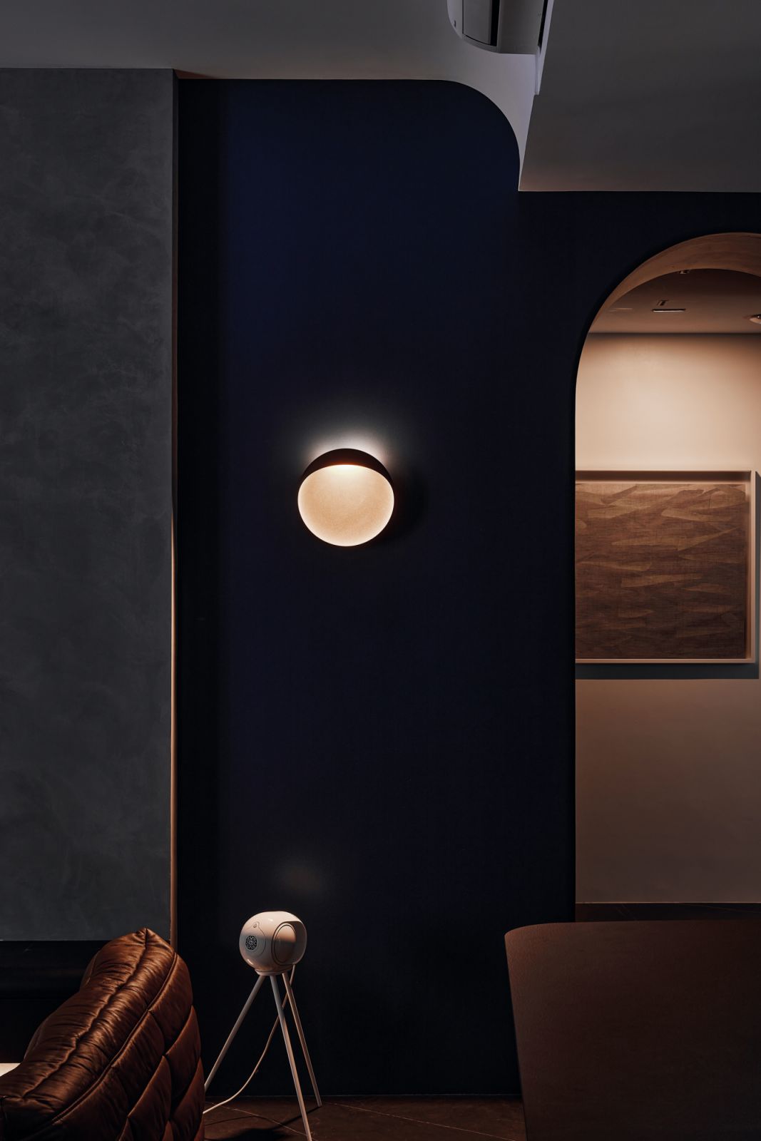This wall sconce highlights the importance of lighting in the design