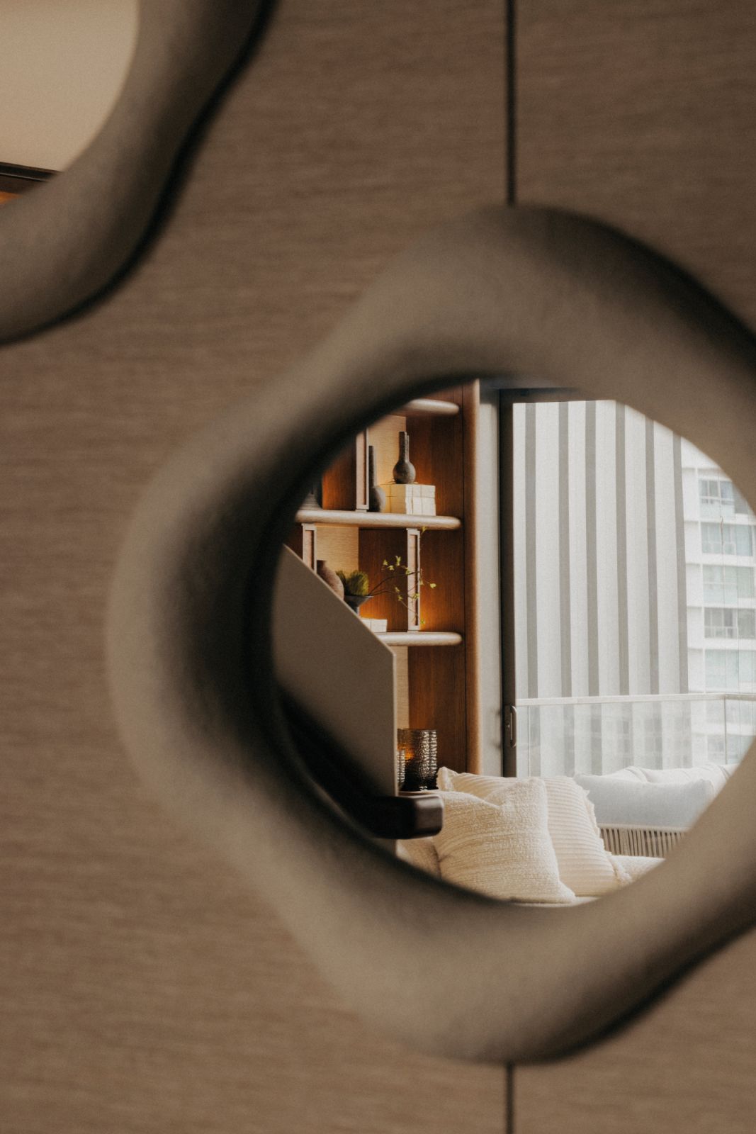 An organically-shaped mirror softens the décor ensemble