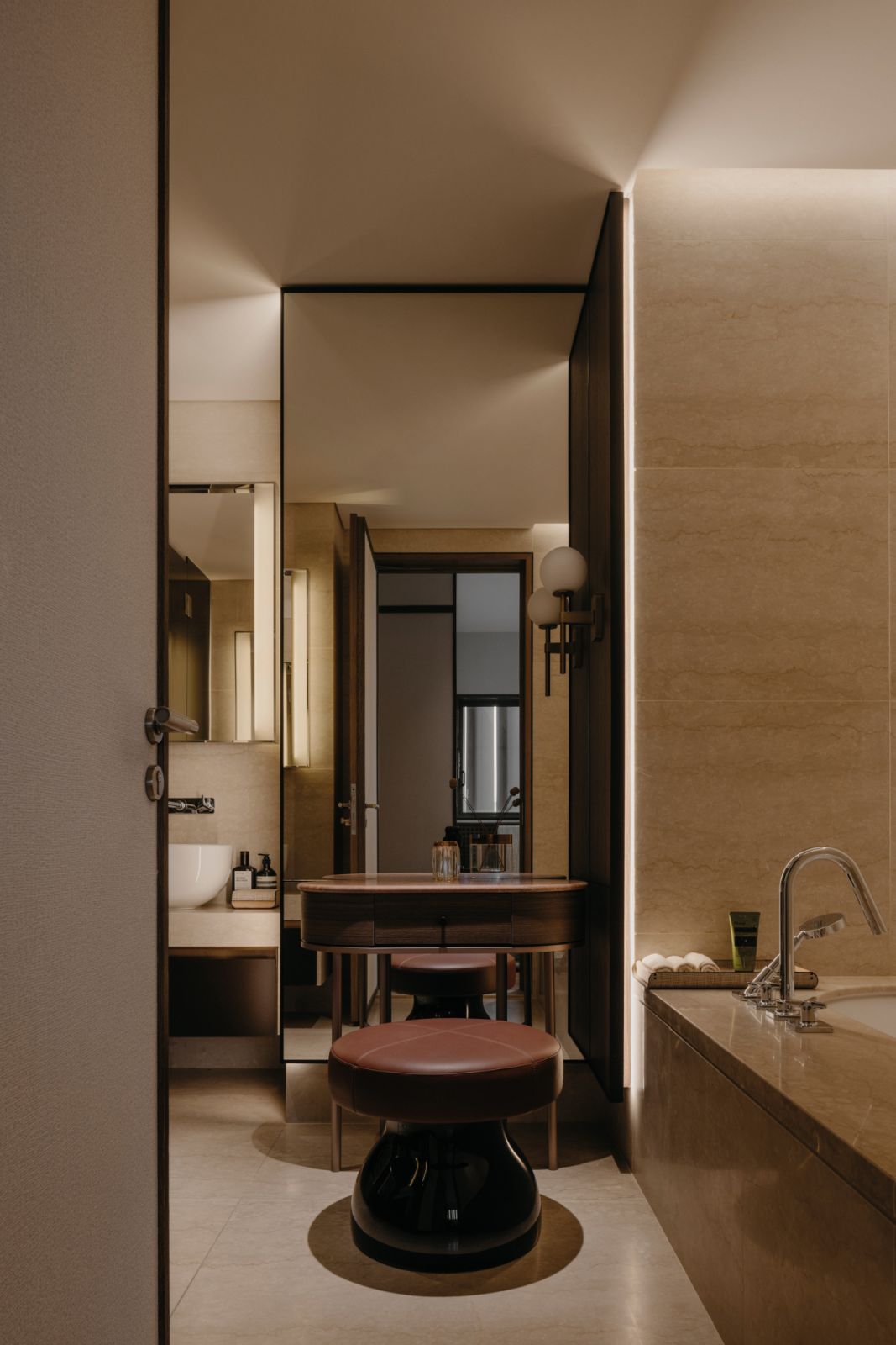 The vanity features a floor-to-ceiling mirror panel that enlarges the bathroom