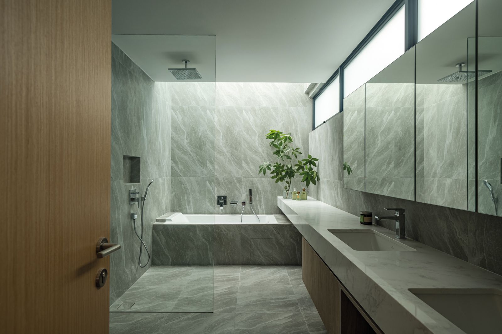 The master bathroom incorporates a double-sink vanity and a bathtub under a skylight