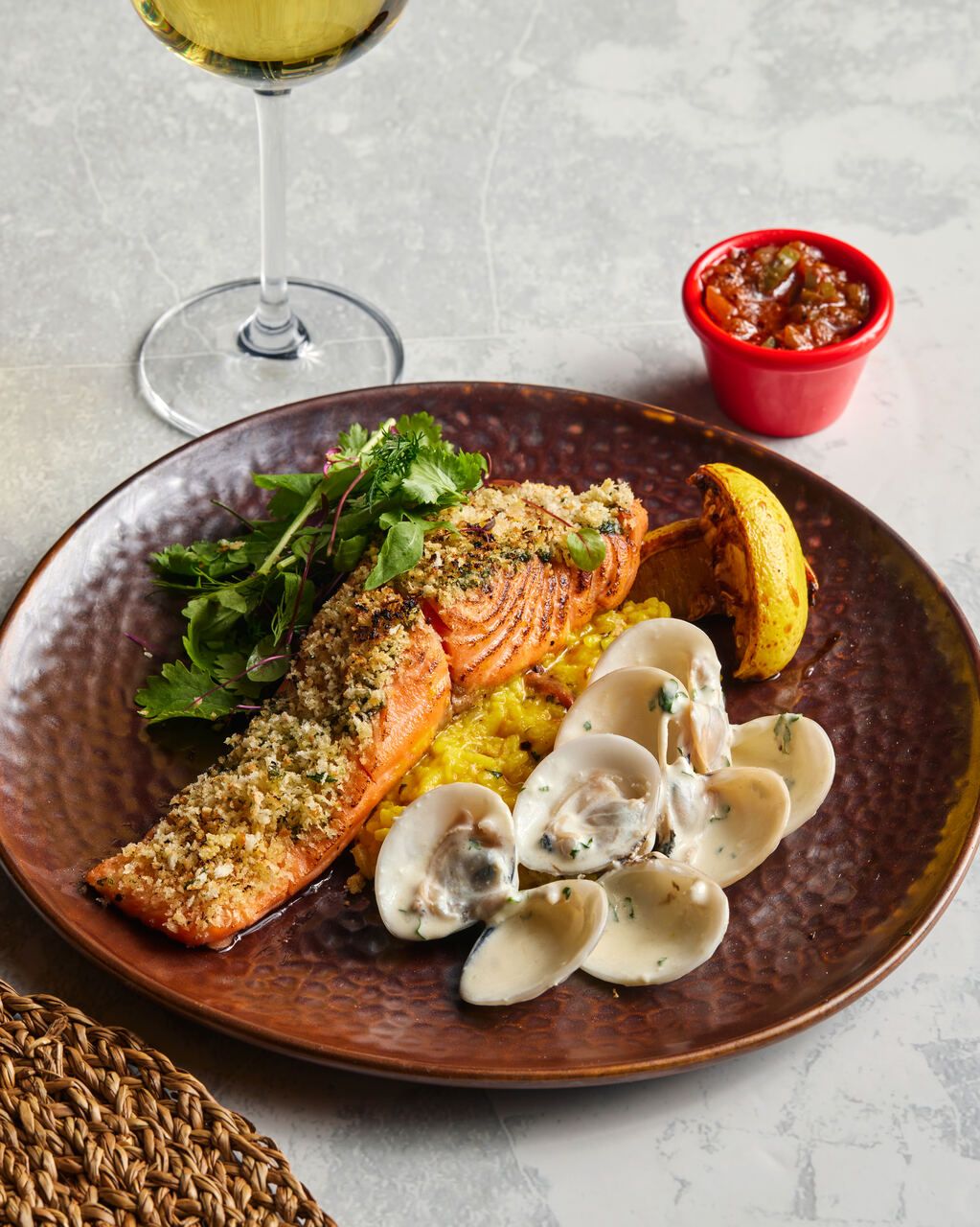 Parmesan Crusted Salmon: oven-baked salmon fillet with a parmesan crust, clams veloute, saffron risotto and mexican salsa