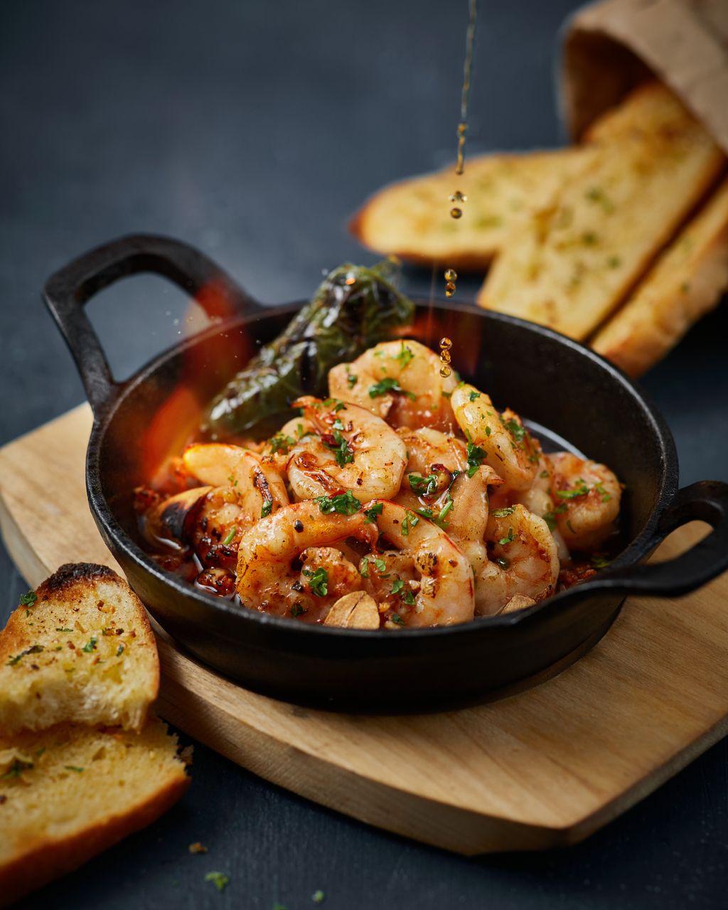 Sizzling Garlic Prawn: succulent prawns sautéed in garlic chilli oil and charred jalapeño, served with toasted garlic bread